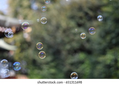 Some floating bubbles get sunshine in front of Japanese old style stairs with red traditional hand rail in spring.