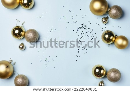 some gold christmas balls and confes on a white background with confectional confection in the middle