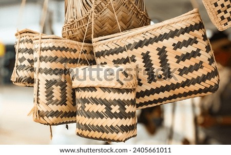 Some indigenous baskets from the Brazilian Amazon, made with palm straw, with a geometric pattern, decorated with natural Genipapo dye