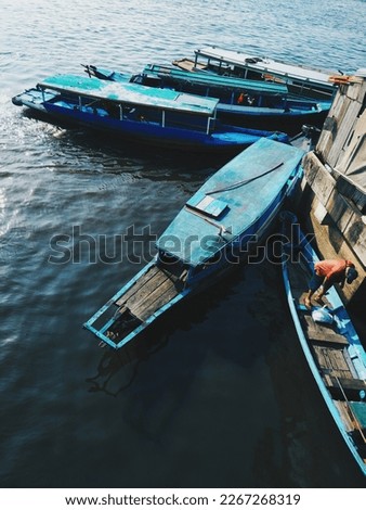 Some mini boats park anchored at riverside. In kalimantan these mini boats called klotok.