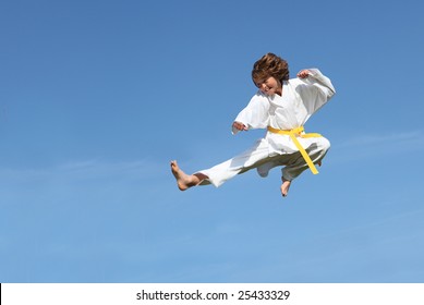 (SOME MOTION BLUR)Karate kid doing karate kick - Powered by Shutterstock