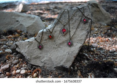 Some necklaces on a stone.