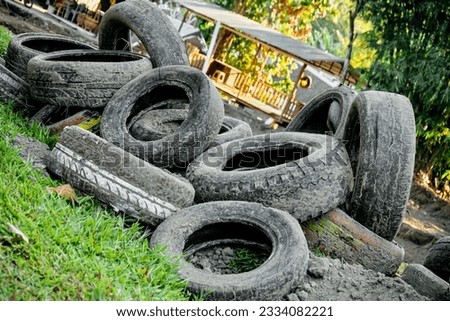 some old tires full of dirt in the garden area