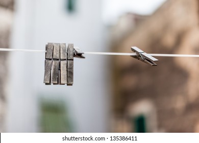 some old and weathered clothes pegs hanged on a whire