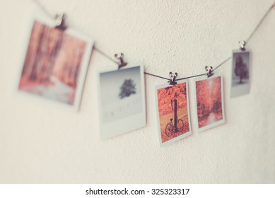 Some Photos Hanging On A Rope, White Wall Background