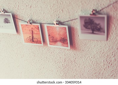 Some Photos Hanging On A Rope, White Wall Background