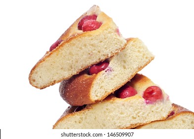 some pieces of coca amb cireres, typical cake of Catalonia, Spain, with cherries, on a white background