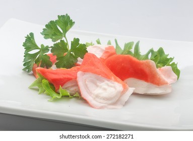 Some Pieces Of Crab Meat, Fresh Lettuce And Parsley On The White Plate