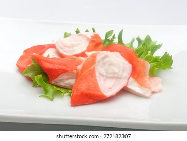 Some Pieces Of Crab Meat, Fresh Lettuce On The White Plate