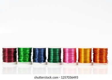 Some  spools of colored metallic thread