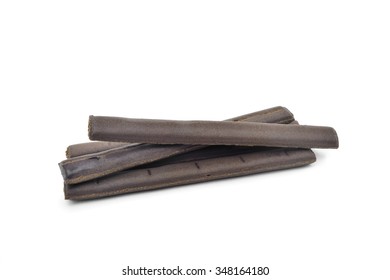 Some Sticks Of Natural Black Licorice On A White Background