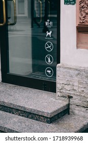 Some Symbols And Signs On The Glass Door Of Coffeeshop . No Smoking , No Alchogol , Wi-fi Free , Dog Friendly . 