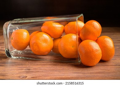 Some Tangernes Falling From A Glass Vase 