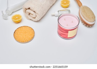 some things that are on the table with it's brush, towel, lemons, and other items