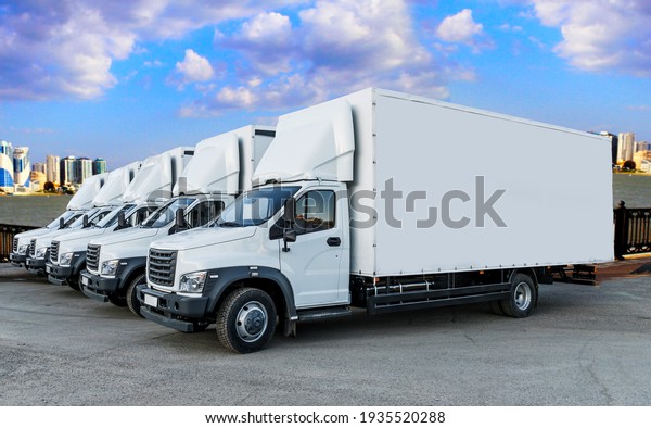 Some trucks are parked in a parking lot next to
a logistics warehouse by the river. Several trucks are lined up in
the parking lot. Logistic
transport
