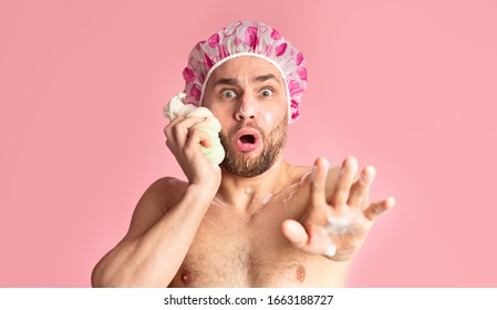 Someone Came To Shower. Scared Guy In Shower Cap Rubs His Face With Sponge