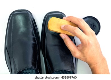 Someone Cleaning Shoes With His Hands.