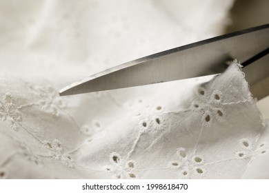 Someone Cuts Batiste With Steel Tailor's Scissors. High quality photo