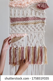 Someone Is Holding A Finished Boho Macra-weave Wall Hanging, A Craft Using Macrame And Weaving Technique, As An Activity During Quarantine. Can Be Used As Home Decor. White Background. Close Up.