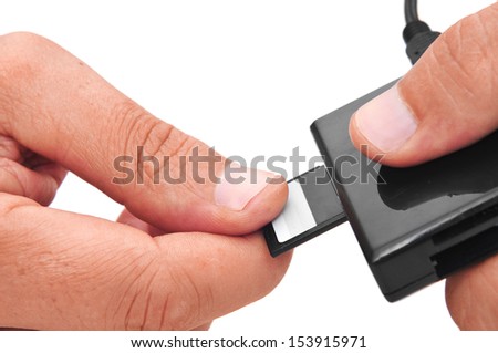 someone inserting a memory card into a memory card reader