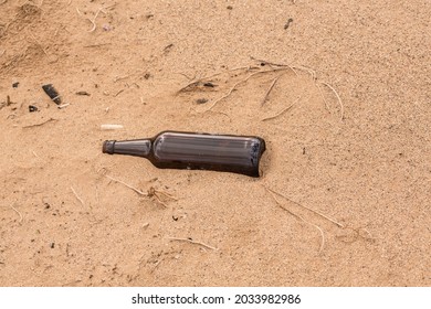 Someone Left An Empty Bottle On The Sand Instead Of Recycled It