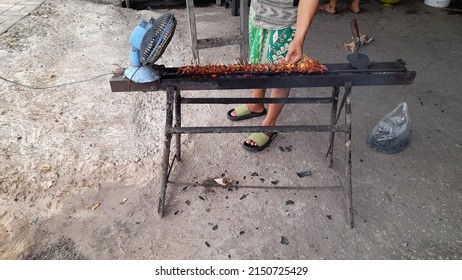 Someone Is Making Grilled Chicken Satay Using A Charcoal Stove, Electric Fan. Restaurant Background Concept, Traditional Cooking Tools, Lifestyle, Cholesterol Food, Finance, Business, Breakfast, Lunch