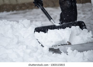 Someone Is  Shoveling Snow Outside In Winter While It Is Snowing