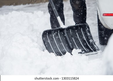 Someone Is  Shoveling Snow Outside In Winter While It Is Snowing