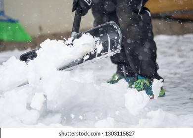 Someone Is  Shoveling Snow Outside In Winter While It Is Snowing