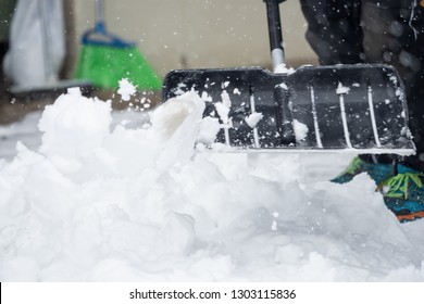 Someone Is  Shoveling Snow Outside In Winter While It Is Snowing