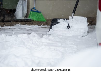 Someone Is  Shoveling Snow Outside In Winter While It Is Snowing