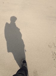 Someone Stood And Photographed His Reflection In The Beach Sand