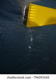 Someone Is Taking The Ice On A Car Away With A Scraper