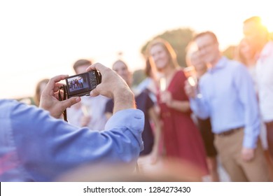 Someone Taking A Photo Of A Group Of People At A Party