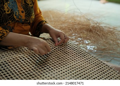 Someone Who Is Making Chair Mats From Woven Rattan