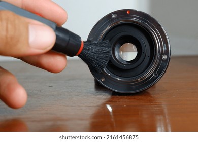 Someone's Hand Cleaning The Mirrorless Camera Lens Mount