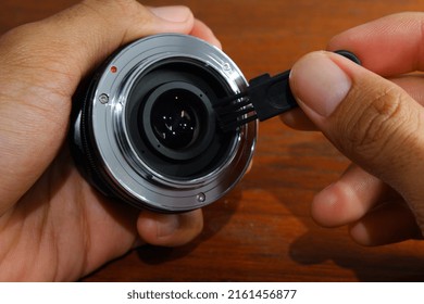 Someone's Hand Cleaning The Mirrorless Camera Lens Mount