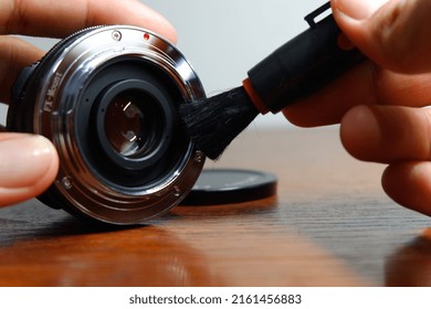 Someone's Hand Cleaning The Mirrorless Camera Lens Mount