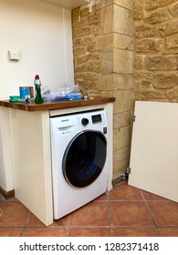 Somerset, UK - 27th March 2018: Installation Of New Washing Machine In A Cabinet. 