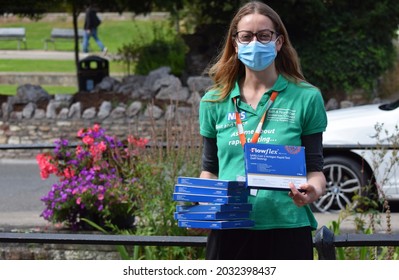 Somerset, UK. August 28 2021. A NHS Volunteer Handing Out Free Covid-19 Lateral Flow Tests To The Public In A Small British Town 