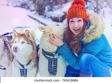 Something about winter and Christmas, Winter is a magical time for dreams come true. Beautiful portrait of woman in the winter snowy scenery. Happy magic moments of pretty woman and Siberian Husky Dog