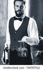 Sommelier holding wine bottle and wine glasses