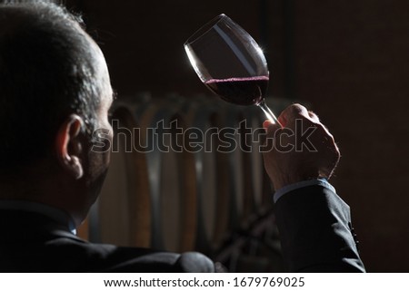 Sommelier makes a selection of red wine from an oak barrel. ecological wine production on the farm. Сток-фото © 