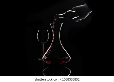 Sommelier pour out red wine from bottle to decanter