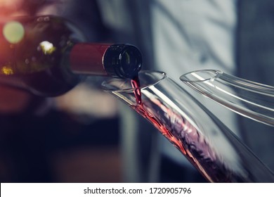 Sommelier Pouring Red Wine Into Carafe Decanter.