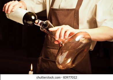 A Sommelier Pouring Red Wine Into Decanter