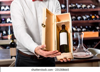 Sommelier Showing Wooden Wine Box With Expensive Wine In The Wine Cellar