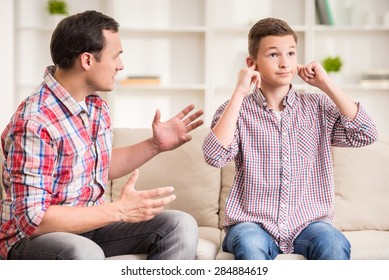 Son closing ears while father scolding  him. - Powered by Shutterstock