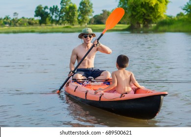 Son And Dad Fishing In A Boat Against The Backdrop Of Beautiful Nature And The River At Sunset Fish.