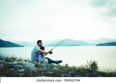 son and dad fishing at dam,vintage tone - Powered by Shutterstock